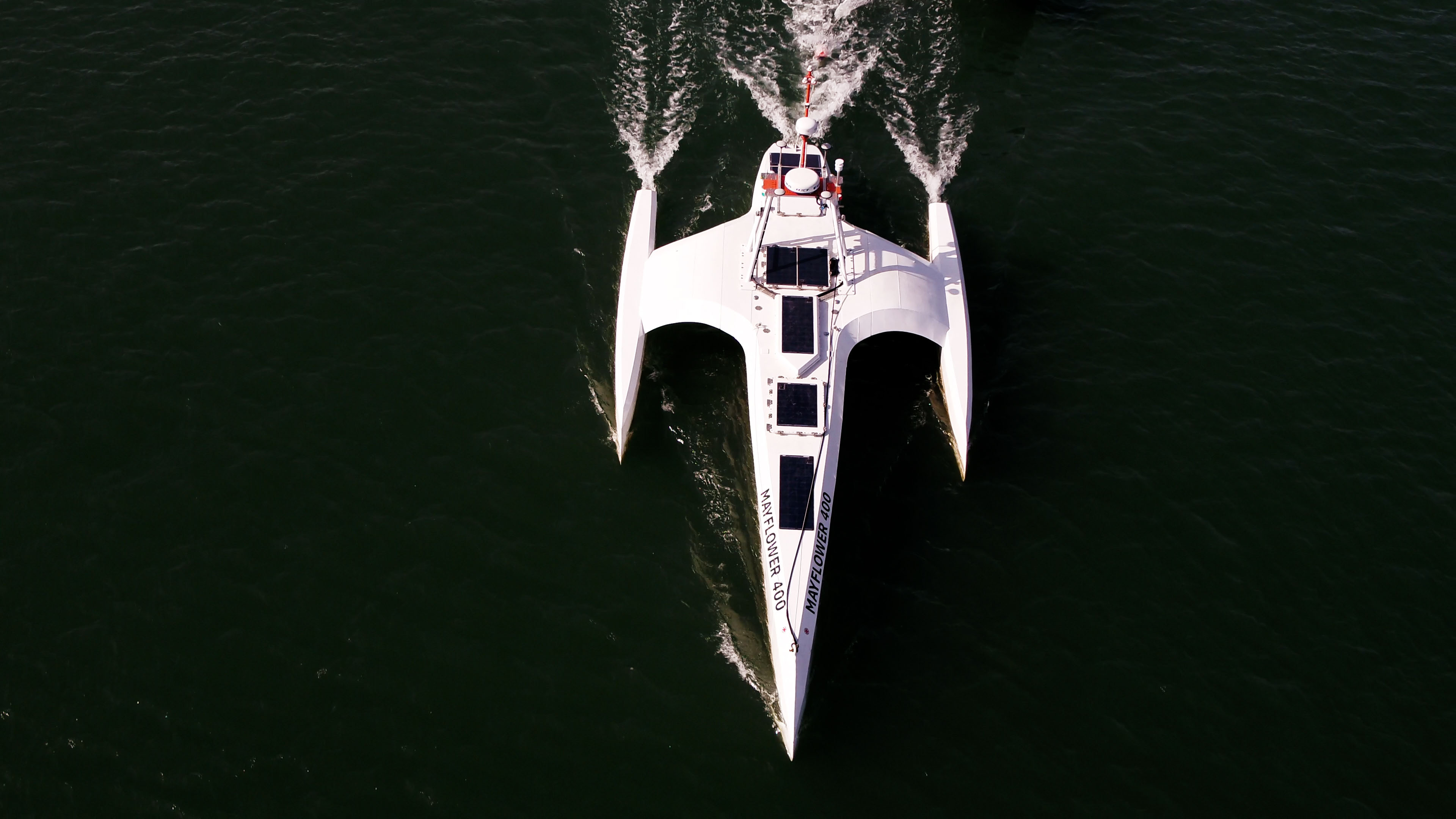 Aerial photo of a large catamaran with solar panels